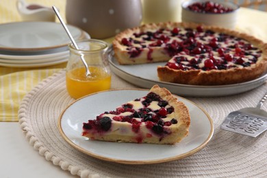 Photo of Piece of delicious currant pie on white table