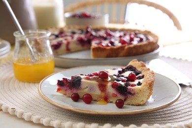 Photo of Piece of delicious currant pie with honey on table indoors, closeup