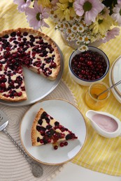 Photo of Delicious currant pie and fresh berries on white table, above view