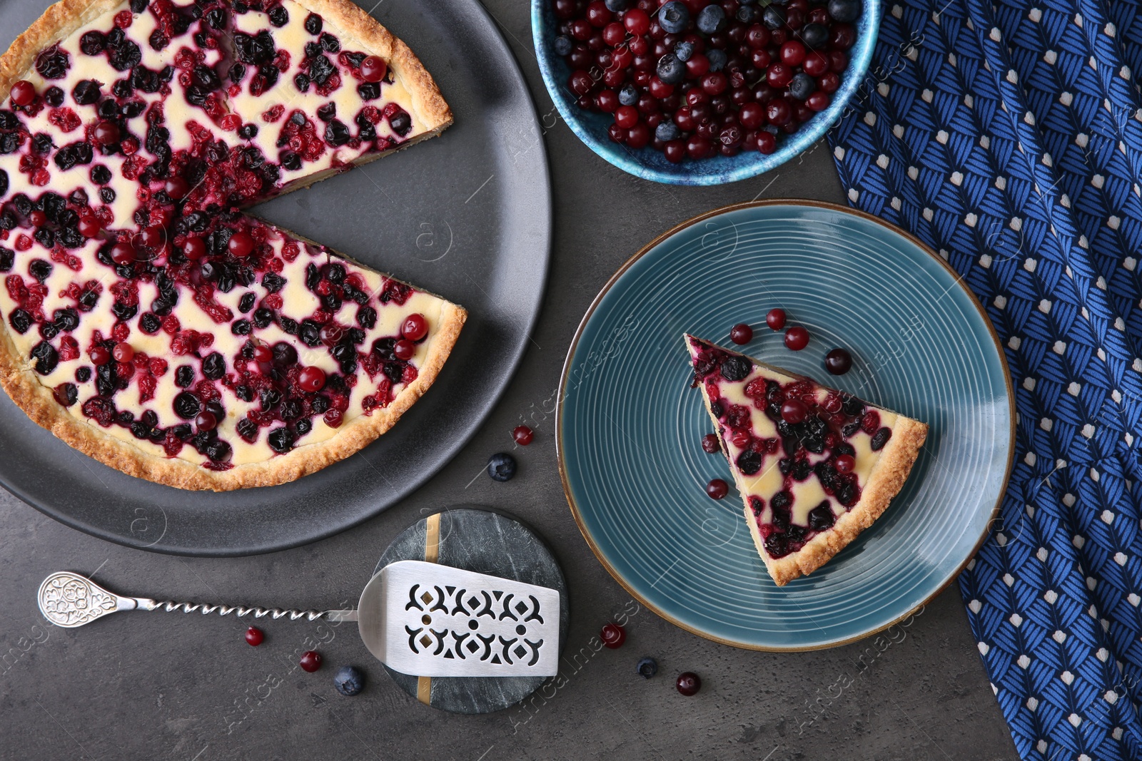 Photo of Delicious currant pie and fresh berries on grey table, flat lay