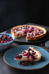 Photo of Piece of delicious currant pie and fresh berries on grey table, space for text