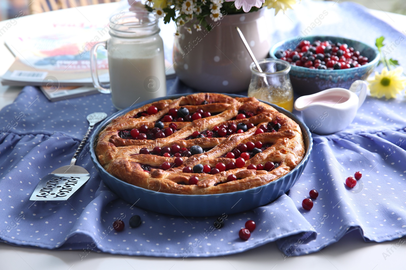 Photo of Delicious currant pie with fresh berries served on white table