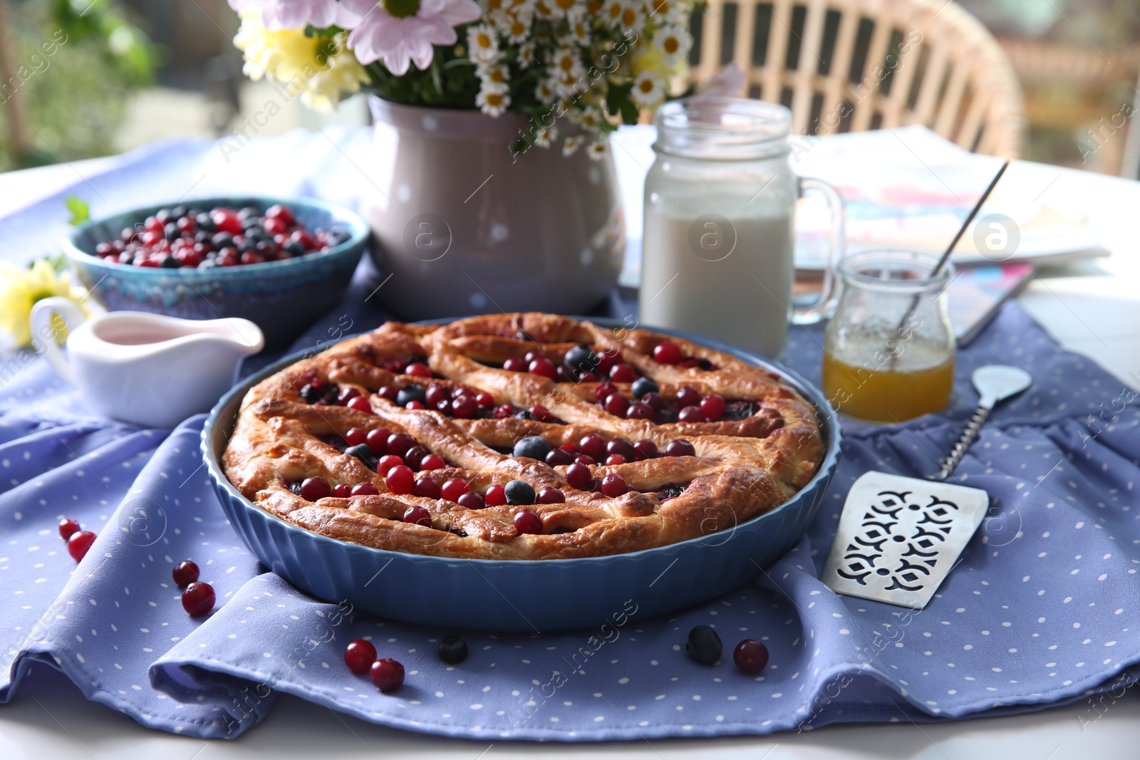 Photo of Delicious currant pie with fresh berries served on white table