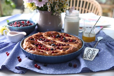 Photo of Delicious currant pie with fresh berries served on white table