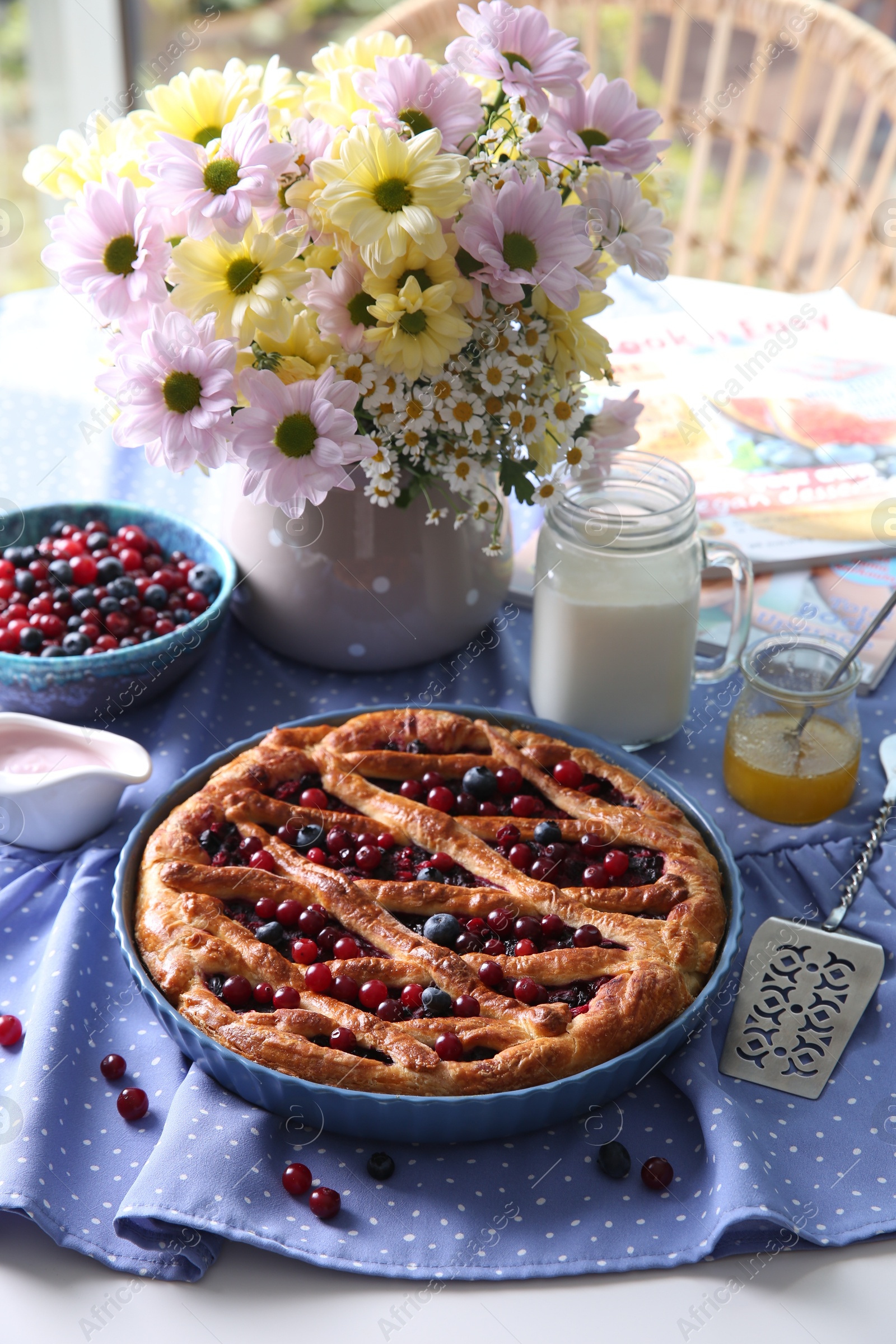 Photo of Delicious currant pie with fresh berries served on white table