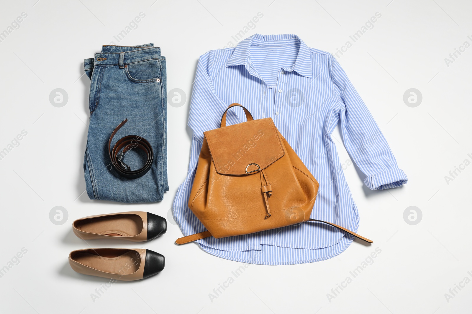 Photo of Stylish outfit with backpack on white background, flat lay