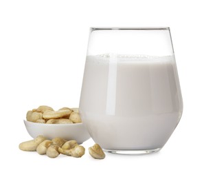 Photo of Fresh cashew milk in glass and nuts isolated on white