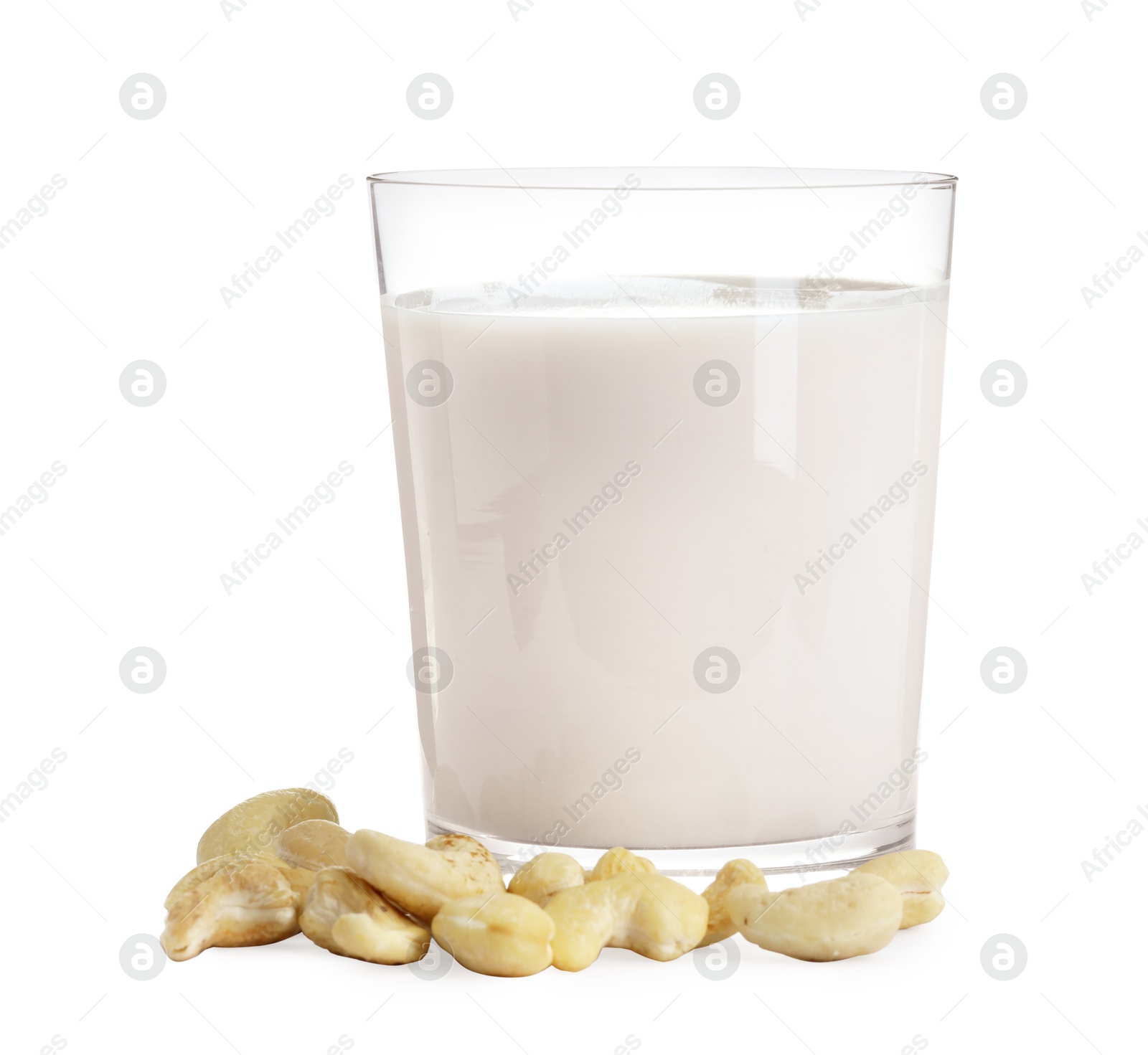 Photo of Fresh cashew milk in glass and nuts isolated on white