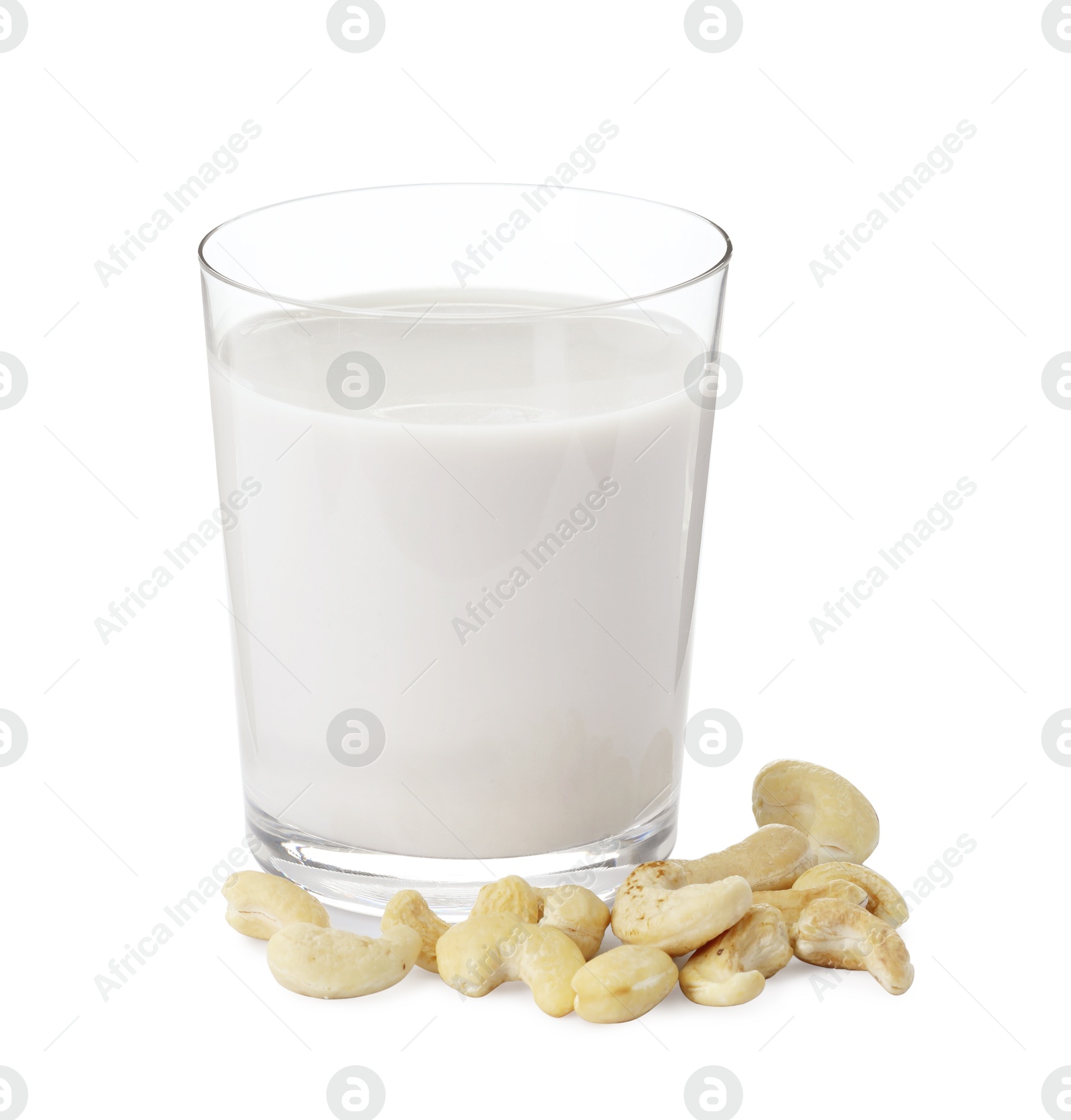 Photo of Fresh cashew milk in glass and nuts isolated on white