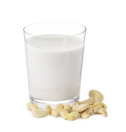 Fresh cashew milk in glass and nuts isolated on white