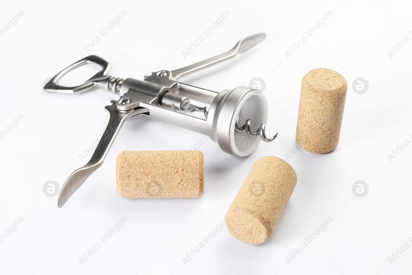 Photo of Wing corkscrew and corks on white background