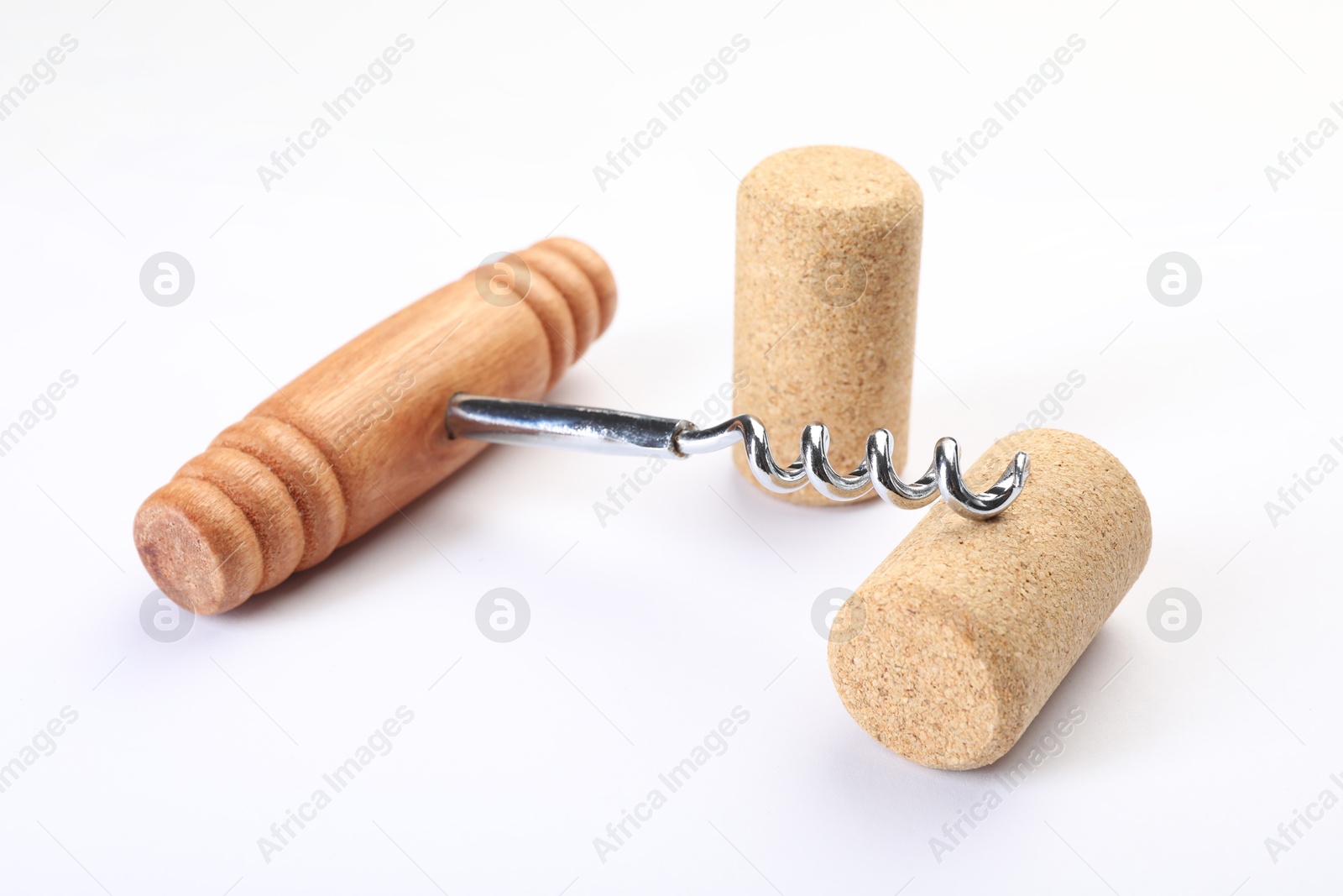 Photo of Corkscrew with wooden handle and corks on white background