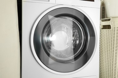 Photo of Washing machine with empty drum as background, closeup