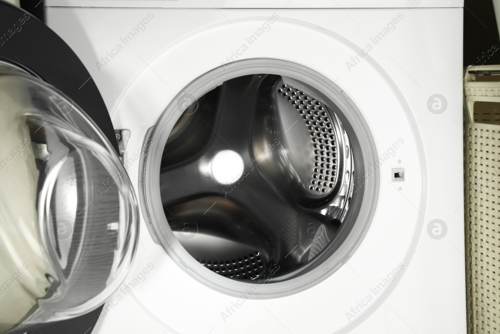 Photo of Washing machine with empty drum as background, closeup