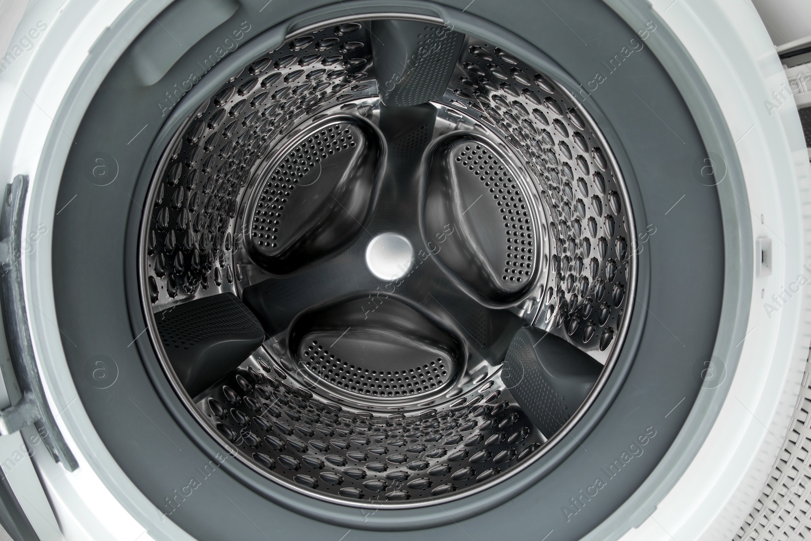 Photo of Washing machine with empty drum as background, closeup