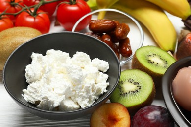 Photo of Different fresh products rich in serotonin on white wooden table