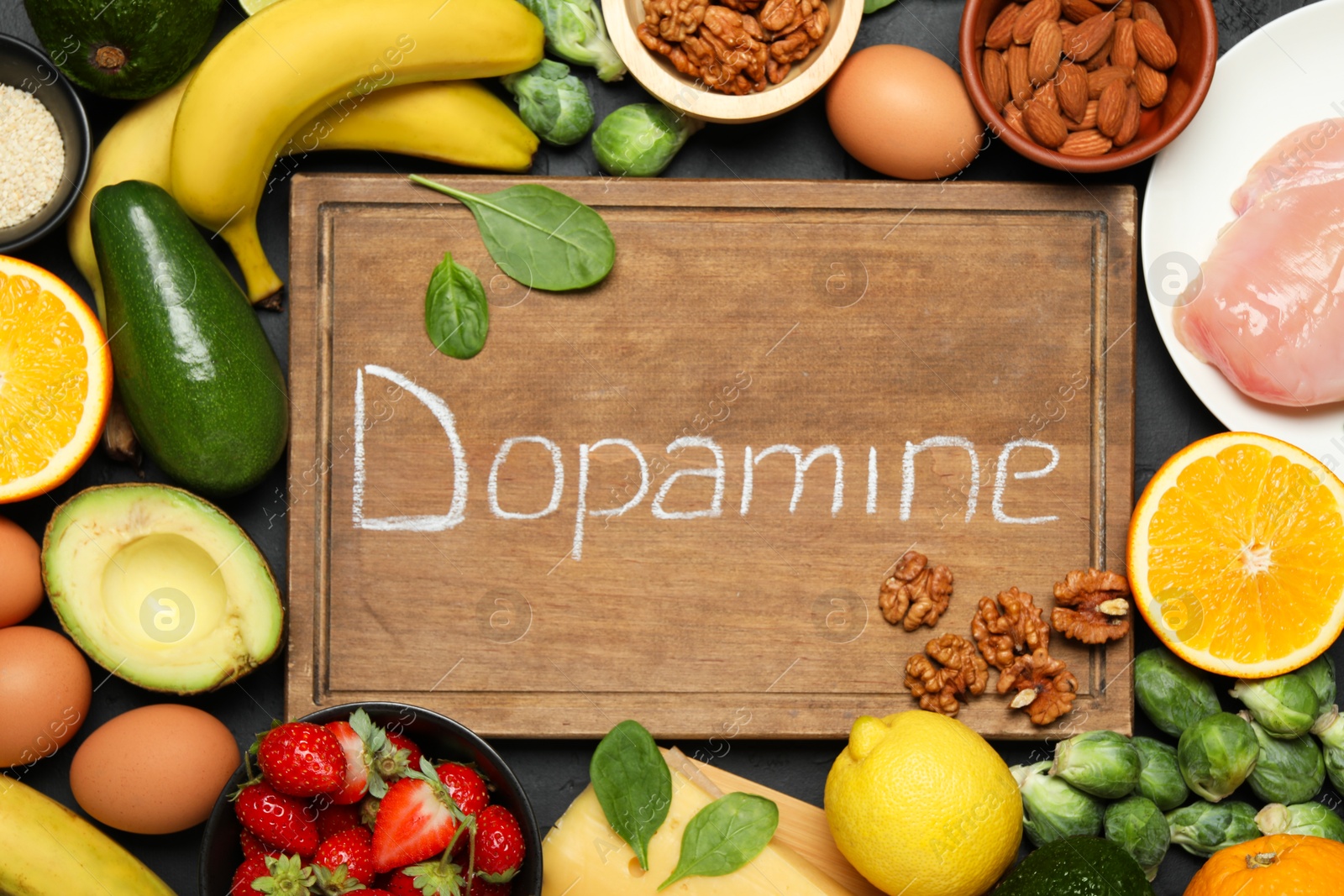 Photo of Wooden board with word Dopamine and different fresh products on grey table, flat lay