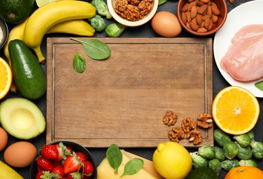 Photo of Wooden board with word Dopamine and different fresh products on grey table, flat lay