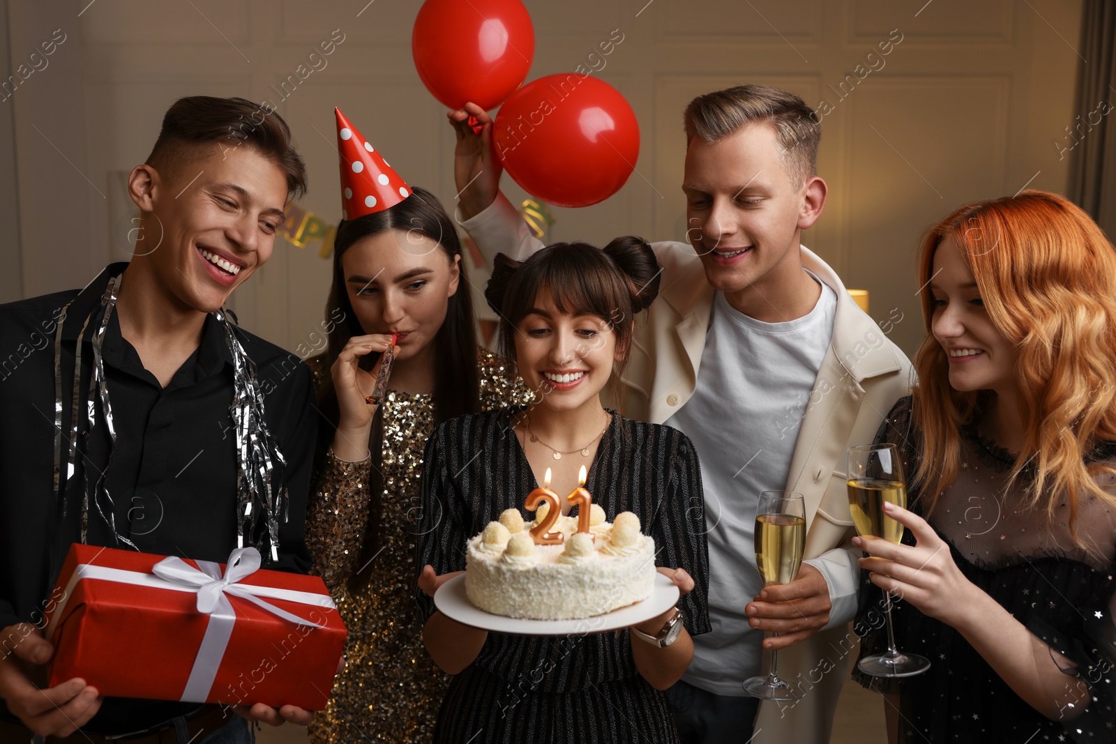 Photo of 21st birthday. Group of happy friends with tasty cake having coming of age party at home