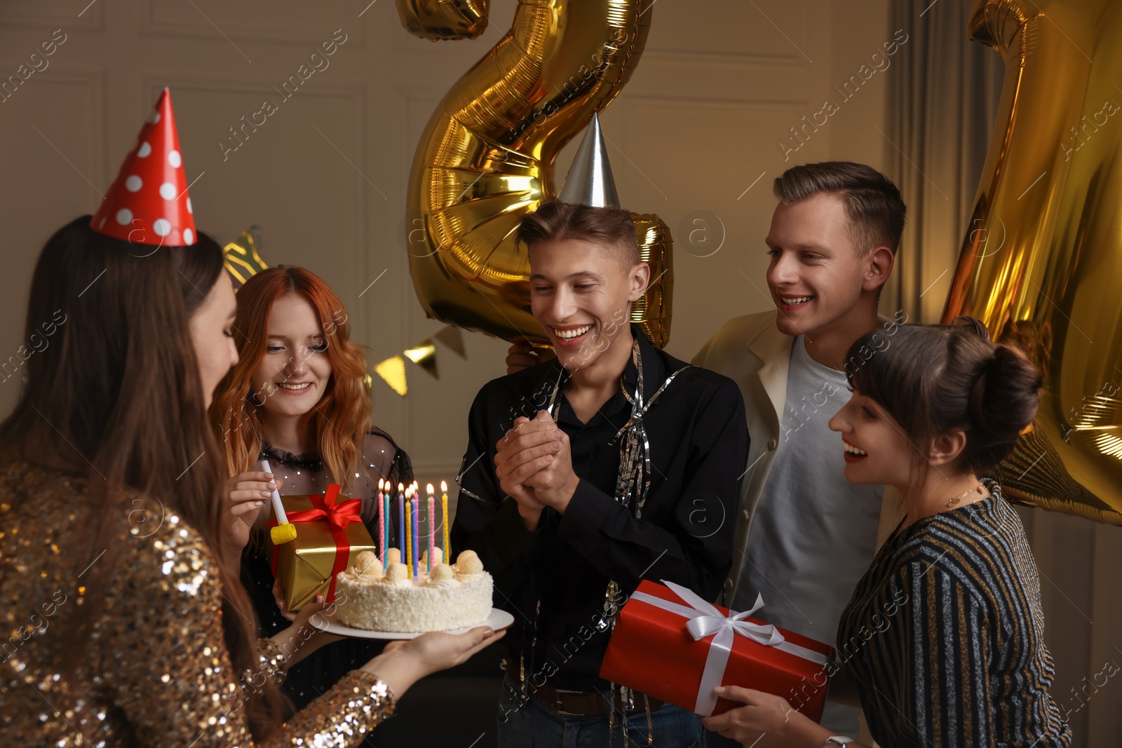 Photo of 21st birthday. Group of happy friends with tasty cake having coming of age party at home