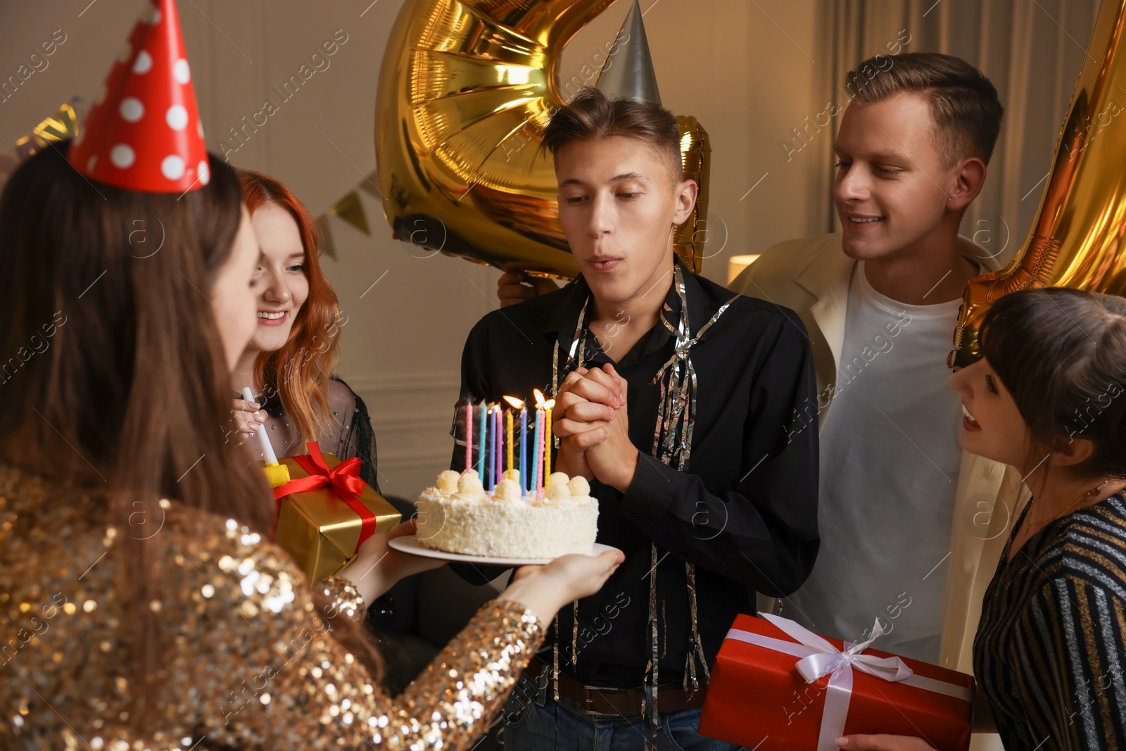 Photo of 21st birthday. Group of happy friends with tasty cake having coming of age party at home