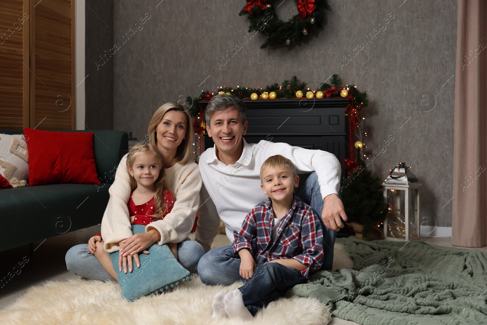 Photo of Beautiful family near fireplace at home. Christmas season