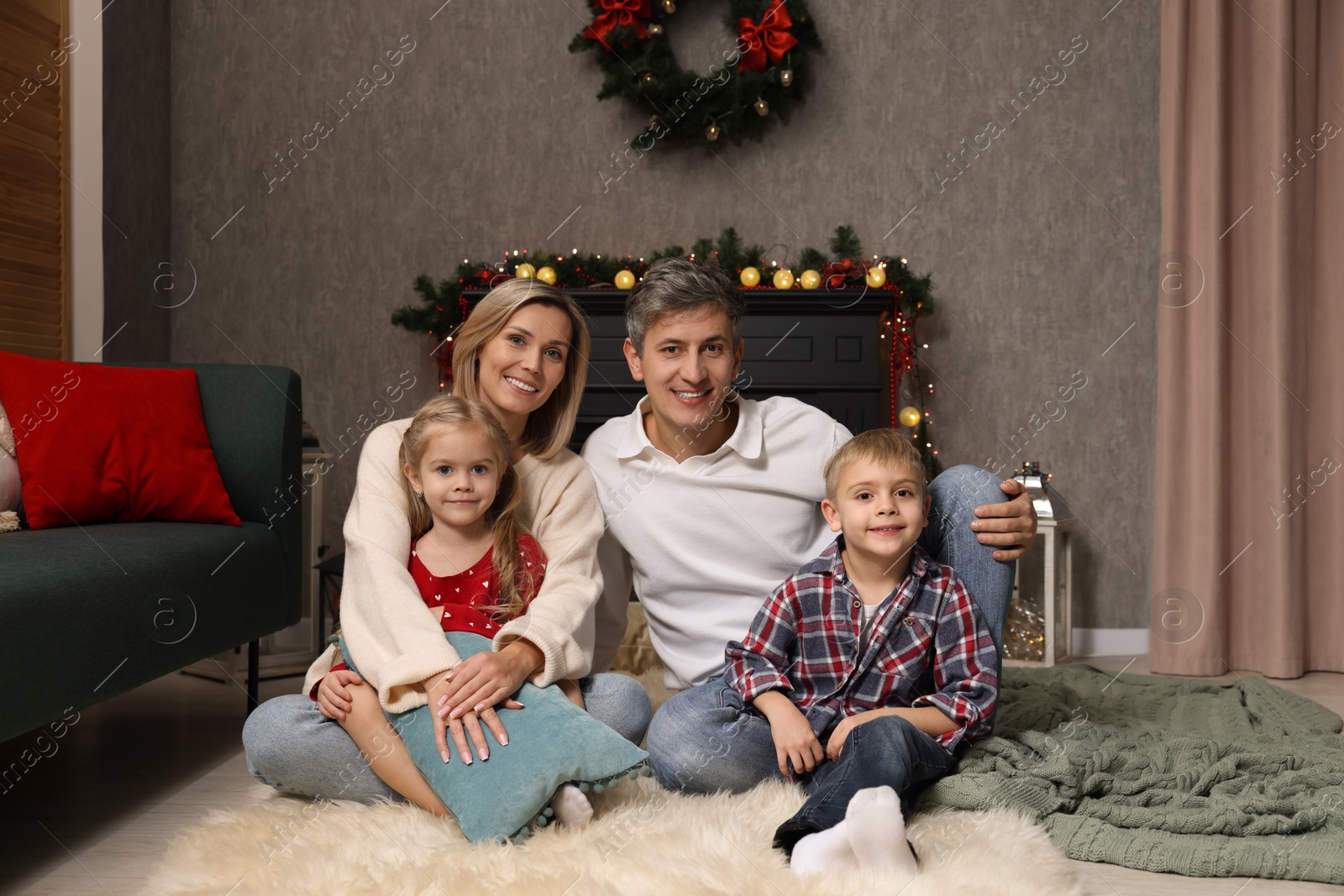 Photo of Beautiful family near fireplace at home. Christmas season