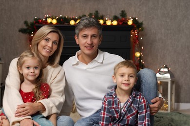 Photo of Beautiful family near fireplace at home. Christmas season