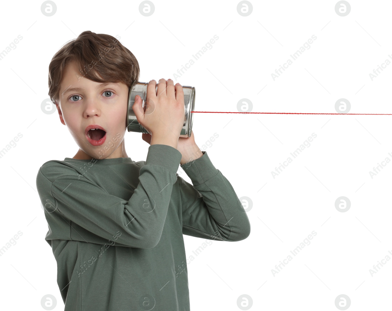 Photo of Emotional boy using tin can telephone on white background