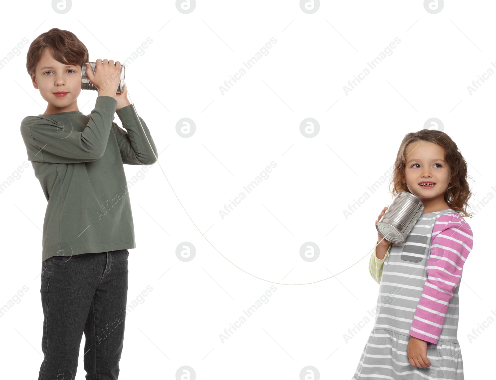 Photo of Boy and girl talking on tin can telephone against white background