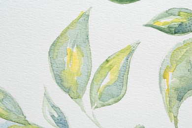 Photo of Watercolor painting of green leaves on white paper, top view