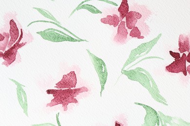 Photo of Watercolor painting of pink flowers and leaves on white paper, top view