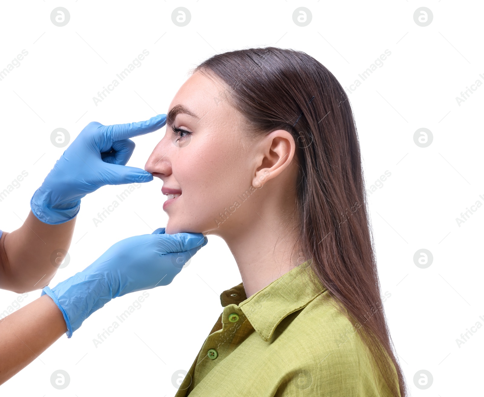 Photo of Doctor checking patient's nose before plastic surgery operation on white background, closeup