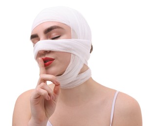 Photo of Woman with nose wrapped in medical bandage after plastic surgery operation on white background