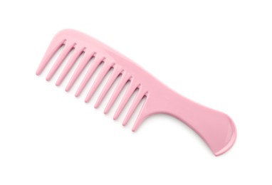 Photo of One pink plastic comb isolated on white, top view