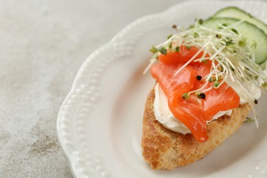 Photo of Delicious bruschetta with salmon, cream cheese and cucumber on light table, closeup. Space for text