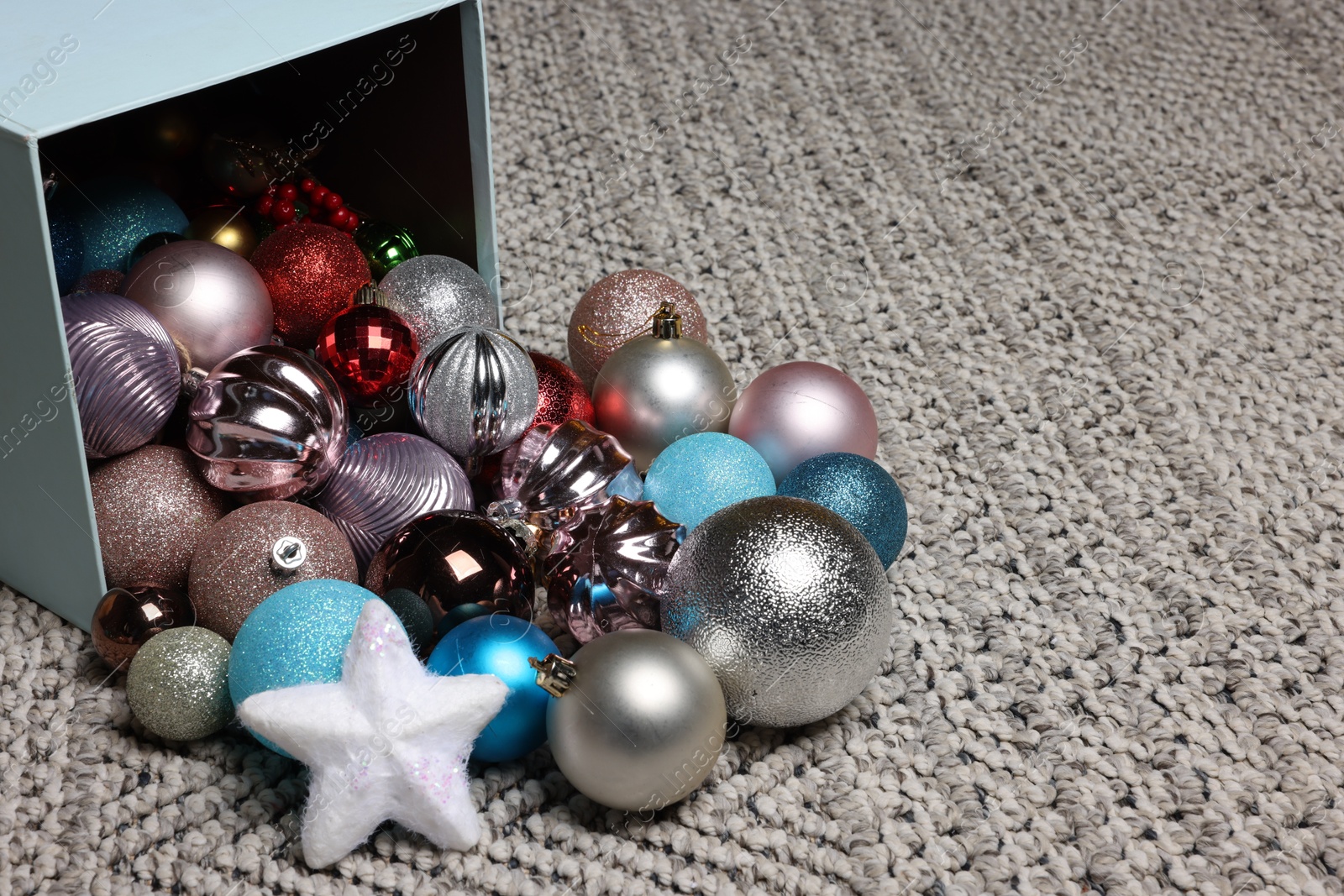 Photo of Different Christmas decor in box on carpet. Space for text