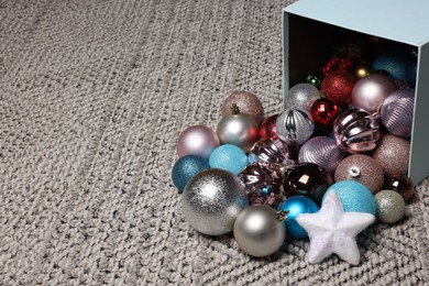 Photo of Different Christmas decor in box on carpet. Space for text