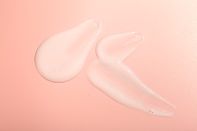 Photo of Cream samples on pink background, top view