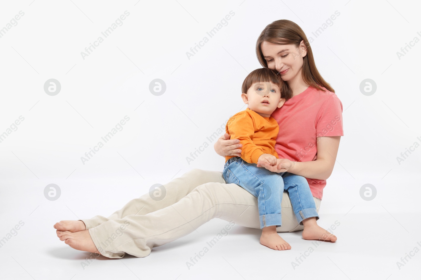 Photo of Beautiful mother with her cute little son on white background