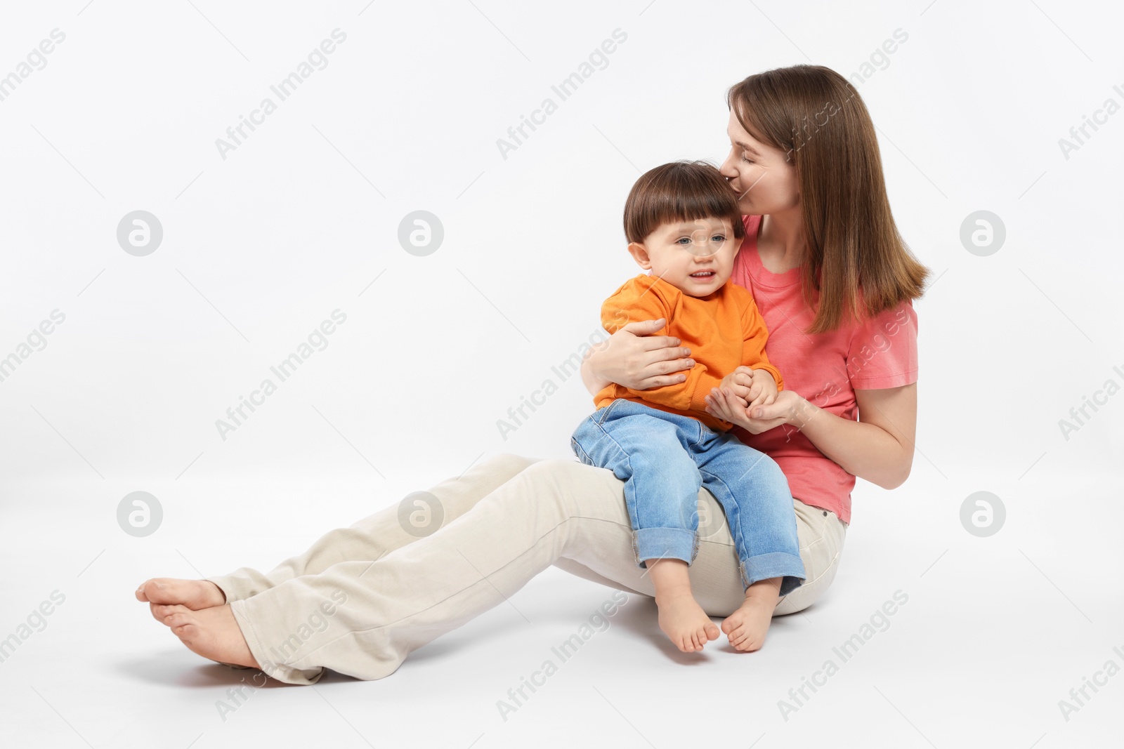 Photo of Beautiful mother with her cute little son on white background