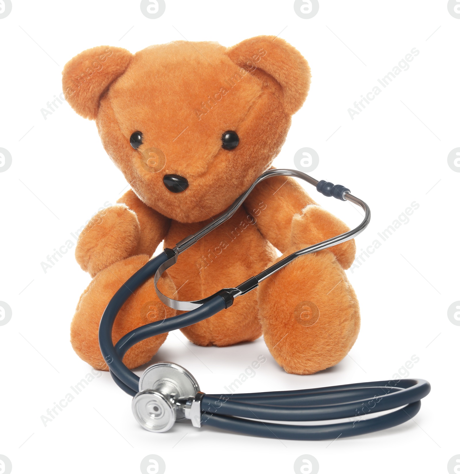 Photo of Pediatrics concept. Teddy bear and stethoscope isolated on white