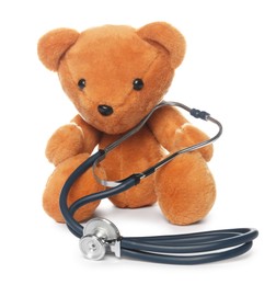 Photo of Pediatrics concept. Teddy bear and stethoscope isolated on white