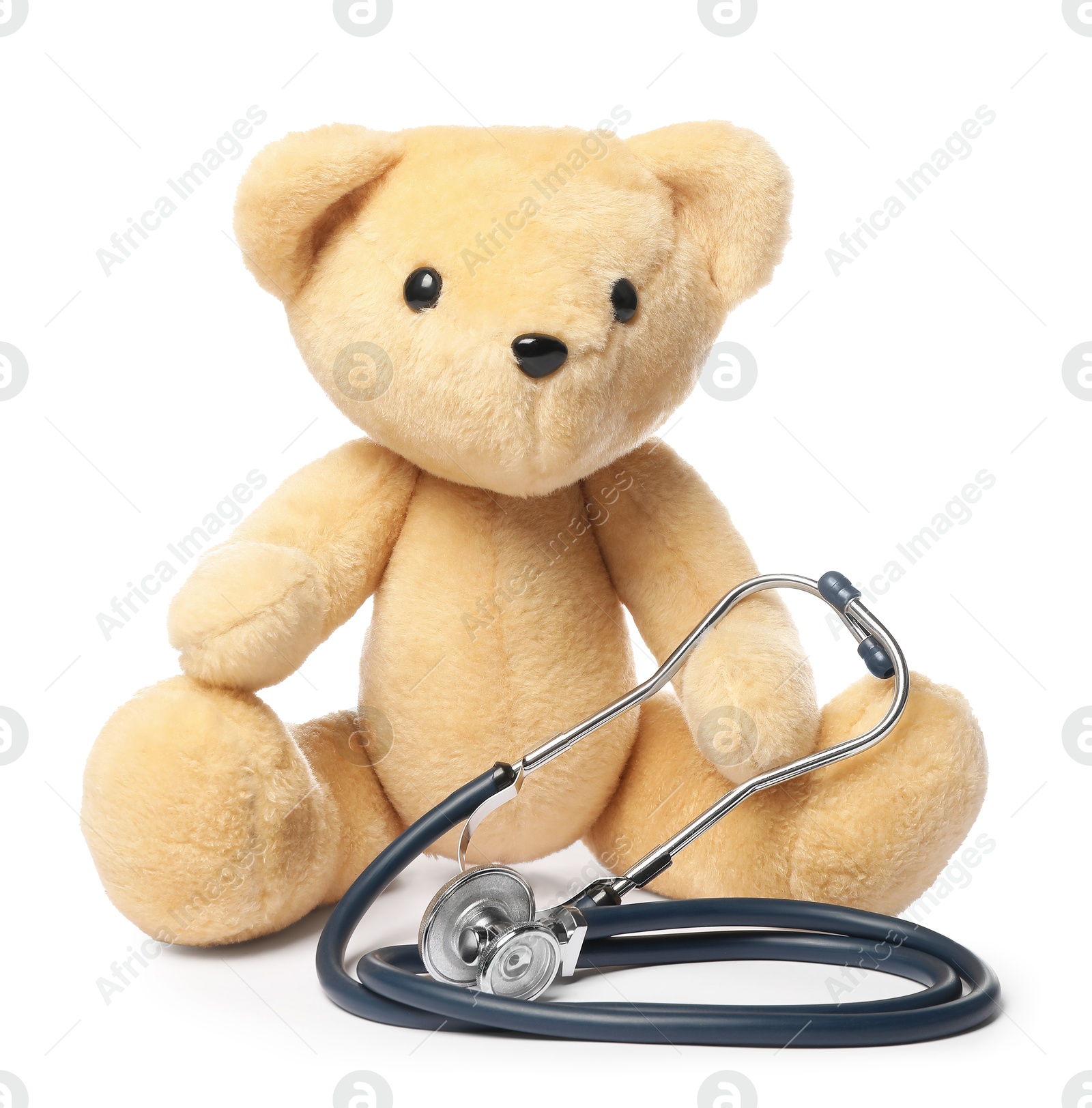 Photo of Pediatrics concept. Teddy bear and stethoscope isolated on white