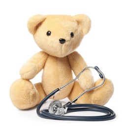 Photo of Pediatrics concept. Teddy bear and stethoscope isolated on white