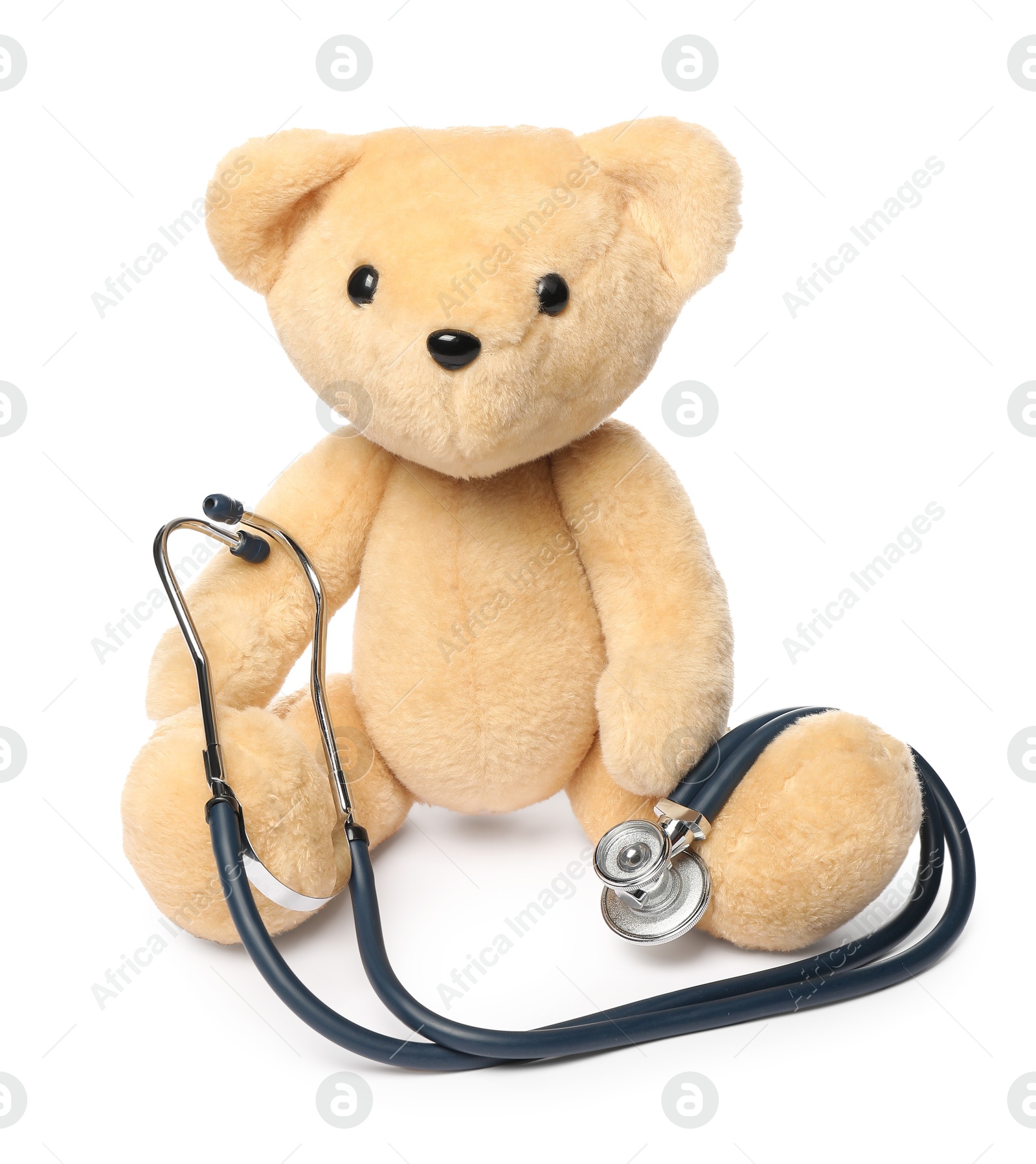 Photo of Pediatrics concept. Teddy bear and stethoscope isolated on white