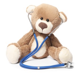 Photo of Pediatrics concept. Teddy bear and stethoscope isolated on white