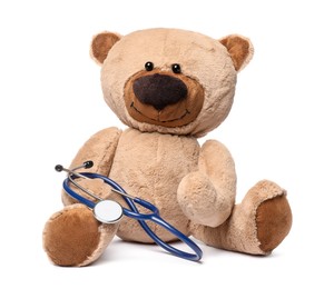 Photo of Pediatrics concept. Teddy bear with stethoscope isolated on white