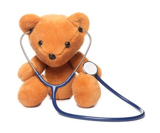 Photo of Pediatrics concept. Teddy bear with stethoscope isolated on white