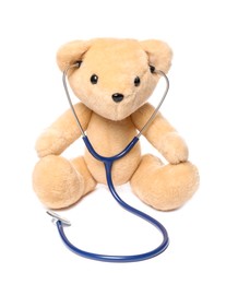 Photo of Pediatrics concept. Teddy bear with stethoscope isolated on white